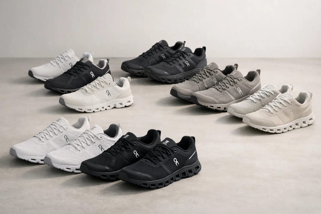 Multiple On Cloud running shoe models arranged on a studio floor in neutral colors, showing different styles for running, training, and everyday wear.